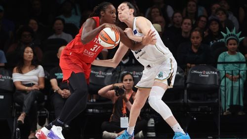 The Atlanta Dream's Tina Charles drives on the New York Liberty's Breanna Stewart in a WNBA game on Thursday, Sept. 19, 2024 in New York.