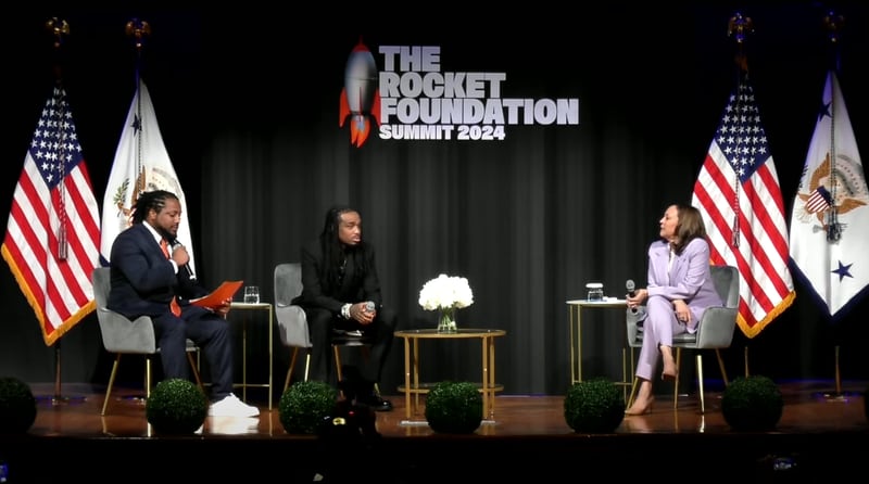 Vice President Kamala Harris (right) holds a conversation with Migos rapper Quavo (center) at the Rocket Foundation Summit that is taking place on former Migos member Takeoff’s birthday, who was shot dead in 2022. (Courtesy of White House livestream screen grab)