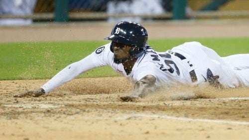 The Detroit Tigers' Travis Demeritte scores from third base on a wild pitch by Nate Jones of the Cincinnati Reds during the seventh inning at Comerica Park in Detroit on Friday, July 31, 2020. The Tigers won, 7-2. (Duane Burleson/Getty Images/TNS)