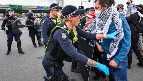 Victoria Police clash with anti-war protesters outside a military arms convention in downtown Melbourne, Australia,Wednesday, Sept. 11, 2024. (Joel Carret/AAP Image via AP)