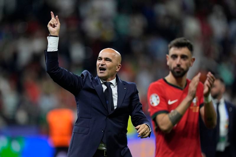 Portugal's head coach Roberto Martinez celebrates after a round of sixteen match between Portugal and Slovenia at the Euro 2024 soccer tournament in Frankfurt, Germany, Monday, July 1, 2024. (AP Photo/Matthias Schrader)