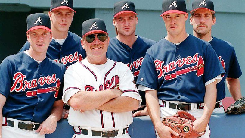 Cleveland Indians hitting coach Eddie Murray, right, pats Indians