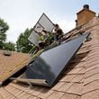 060722 Ellenwood: Alternative Energy Southeast employees Aaron Basto, center, and Russell McCune, right, installs eighteen solar panels to the roof of a resident Tuesday, June 7, 2022, in Ellenwood, Ga. (Jason Getz / Jason.Getz@ajc.com)