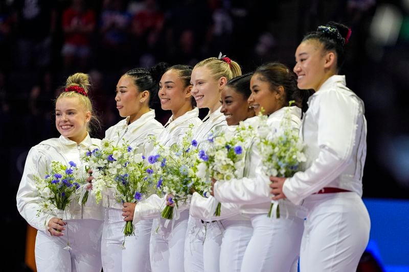 From left to right, Joscelyn Roberson, Suni Lee, Hezly Rivera, Jade Carey, Simone Biles, Jordan Chiles and Leanne Wong smiles after they were named to the 2024 Olympic team at the United States Gymnastics Olympic Trials on Sunday, June 30, 2024, in Minneapolis. (AP Photo/Abbie Parr)