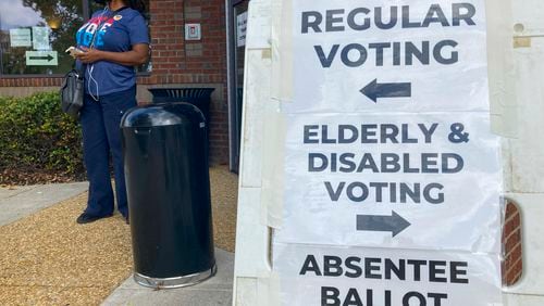 FILE - Signs to guide voters are posted outside a Cobb County polling station on the first day of early voting, in Marietta, Ga., Oct. 17, 2022. (AP Photo/Mike Stewart, File)