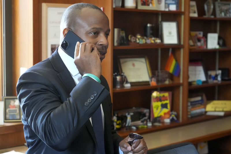 Milwaukee Mayor Cavalier Johnson talks on his phone after an Associated Press interview about the Republican National Convention coming to Milwaukee in his office Monday, July 1, 2024, in Milwaukee. (AP Photo/Morry Gash)