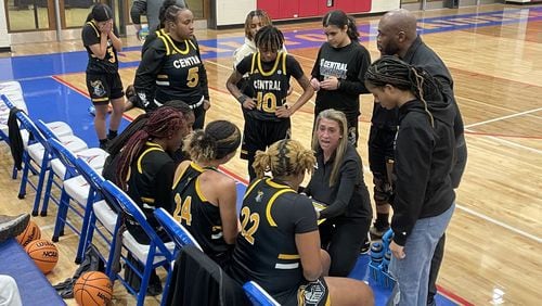 Central Gwinnett coach Courtney Harris talks to her team before the start of the fourth quarter of the Black Knights' 76-48 victory over Walton in the second round of the Class 7A playoffs in Marietta on Feb. 24, 2023.