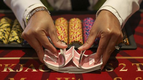 Leadership Sandy Springs will celebrate its 35th anniversary with a fundraising gala in February. The event is being planned with an “Old Hollywood Glam theme” and will include live music and dancing as well as casino games such as blackjack, poker and roulette. Pictured is a dealer shuffling cards at a blackjack table during Diamond Casino Night at the Delta Club in Truist Park in January.  (Jason Getz / Jason.Getz@ajc.com)