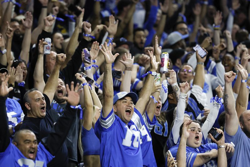 Detroit Lions fans celebrate a Detroit Lions running back Jahmyr Gibbs (26) touchdown run against the Los Angeles Rams during the first half of an NFL football game in Detroit, Sunday, Sept. 8, 2024. (AP Photo/Duane Burleson)