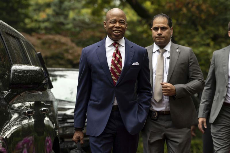 New York City Mayor Eric Adams, left, exits Gracie Mansion, the official residence of the mayor, Thursday, Sept. 26, 2024, in New York. (AP Photo/Yuki Iwamura)