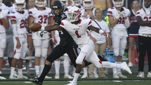 Milton CB Tyreek Rock (1) tries to get his hand on the ball before Alpharetta's Austin Frazier (24).