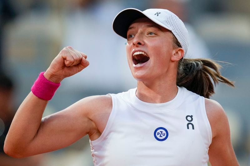 FILE - Poland's Iga Swiatek celebrates winning her semifinal match of the French Open tennis tournament of the French Open tennis tournament against Brazil's Beatriz Haddad Maia in two sets, 6-2, 7-6 (9-7), at Roland Garros stadium in Paris, Thursday, June 8, 2023. The 22-year-old from Poland will be trying to become the first woman to win three consecutive French Opens since Justine Henin collected a trio from 2005 to 2007. (AP Photo/Christophe Ena, File)