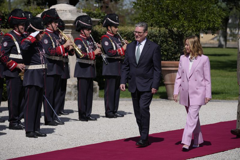 Italian Premier Giorgia Meloni, right, welcomes U.K. Prime Minister Keir Starmer as they meet at Villa Panphilj in Rome, Monday, Sept. 16, 2024. U.K. Prime Minister Keir Starmer is meeting Italian Premier Giorgia Meloni in Rome on Monday, as the two very different politicians, from left and right, seek common cause to curb migrants reaching their shores by boat. The visit comes after at least eight seaborne migrants died off the French coast over the weekend. (AP Photo Andrew Medichini)