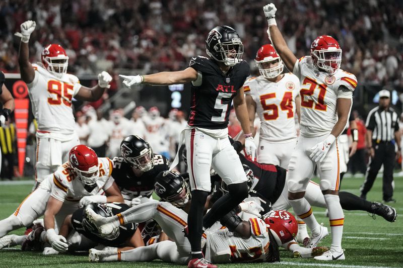 Atlanta Falcons wide receiver Drake London (5) celebrates a touchdown by running back Bijan Robinson (7) against the Kansas City Chiefs during the first half of an NFL football game, Sunday, Sept. 22, 2024, in Atlanta. (AP Photo/Brynn Anderson)