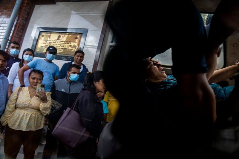 An injured woman is brought for treatment at a hospital, after a bus carrying Indian tourists fell into a river near Abukhaireni town about 75 miles west of the capital Kathmandu, Nepal, Friday, Aug. 23, 2024. (AP Photo/Niranjan Shrestha)