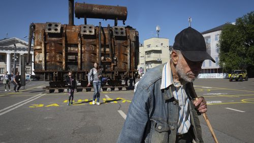 A man passes by a burnt transformer from one of power plants badly damaged in one of Russia's recent missile attacks on energy system in Kyiv, Ukraine, Thursday, Sept. 19, 2024. (AP Photo/Efrem Lukatsky)