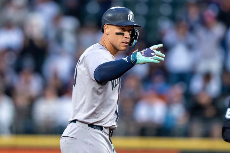 New York Yankees' Aaron Judge gestures to the dugout after hitting a two-run double during the first inning of a baseball game against the Seattle Mariners, Tuesday, Sept. 17, 2024, in Seattle. (AP Photo/Stephen Brashear)