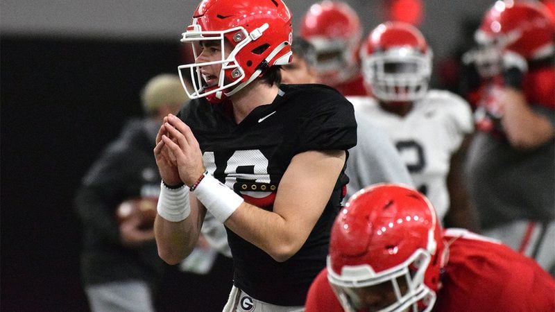 Georgia quarterback JT Daniels (18) takes a snap during the Bulldogs’ practice session for the Chick-fil-A Peach Bowl Monday, Dec. 28, 2020, in Athens. The Bulldogs will face Cincinnati in Atlanta. (Tony Walsh/UGA Sports)