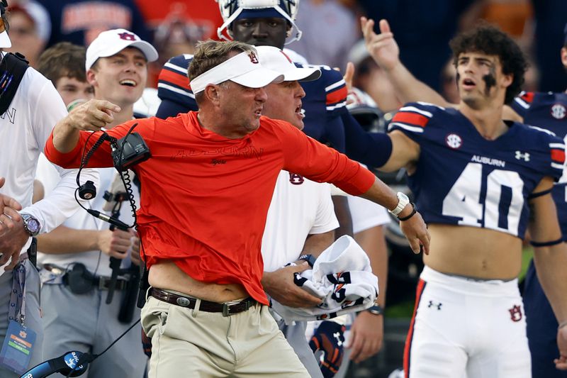 Auburn head coach Hugh Freeze tosses his head set after a play during the second half of an NCAA college football game against Arkansas, Saturday, Sept. 21, 2024, in Auburn, Ala.(AP Photo/Butch Dill)