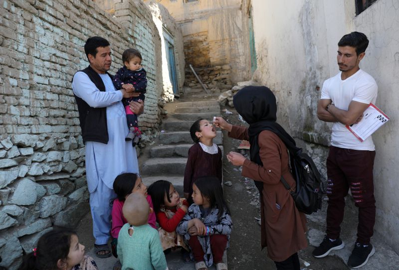 FILE - Shabana Maani, gives a polio vaccination to a child in the old part of Kabul, Afghanistan, Monday, March 29, 2021. (AP Photo/Rahmat Gul, File)