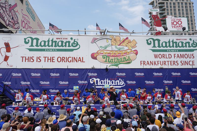 Competitive eaters participate in the women's division in Nathan's Famous Fourth of July hot dog eating contest, Thursday, July 4, 2024, at Coney Island in the Brooklyn borough of New York. (AP Photo/Julia Nikhinson)