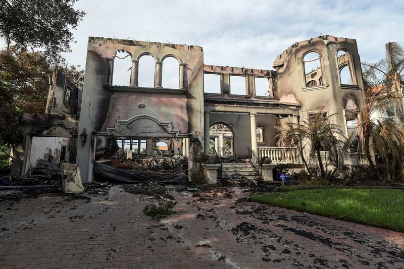 The remains of a home on Davis Island that burned during Hurricane Helene on Saturday, Sept. 28, 2024, in Tampa, Fla. (AP Photo/Mike Carlson)