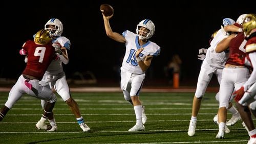 Cambridge quarterback Zach Harris (15) throws the ball during a GHSA high school football game between Cambridge High School and Johns Creek High School in Johns Creek, Ga. on Friday, October 15, 2021. (Photo/Jenn Finch)