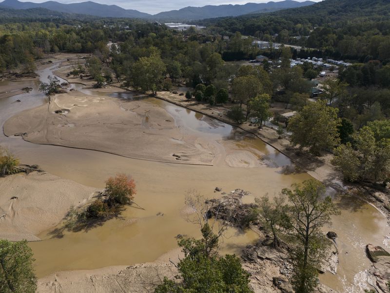 Water is seen outside the banks of the Swannanoa river in the aftermath of Hurricane Helene, Tuesday, Oct. 1, 2024, in Swannanoa, N.C. (AP Photo/Mike Stewart)