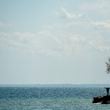 FILE - People are silhouetted as they look out over Lake Ontario in Toronto, April 27, 2020. (Nathan Denette/The Canadian Press via AP, File)