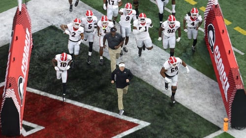 Head coach Kirby Smart leads Georgia as they take the field at the 2022 College Football Playoff National Championship against the Alabama Crimson Tide at Lucas Oil Stadium in Indianapolis on Monday, Jan. 10, 2022.   Bob Andres / robert.andres@ajc.com