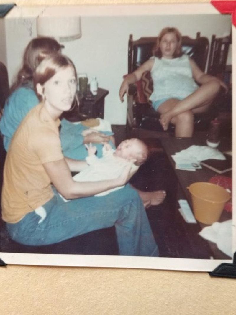 Chris Orris, just days after his birth, inside the family’s home at Tawara Terrace family housing on Camp Lejeune. The woman seated in the white shirt is, Barb, their neighbor across the street. She was about eight months pregnant and lost the baby shortly after this photo was taken. FAMILY PHOTO