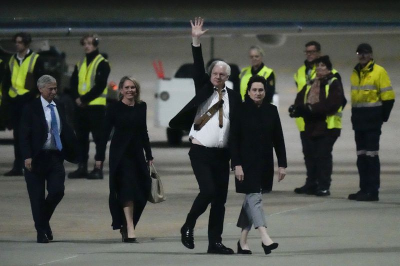 FILE - WikiLeaks founder Julian Assange waves after landing at RAAF air base Fairbairn in Canberra, Australia, June 26 2024. The abrupt guilty plea by WikiLeaks founder Julian Assange was the culmination of negotiations that began a year and a half ago and accelerated in recent months. (AP Photo/Rick Rycroft, File)