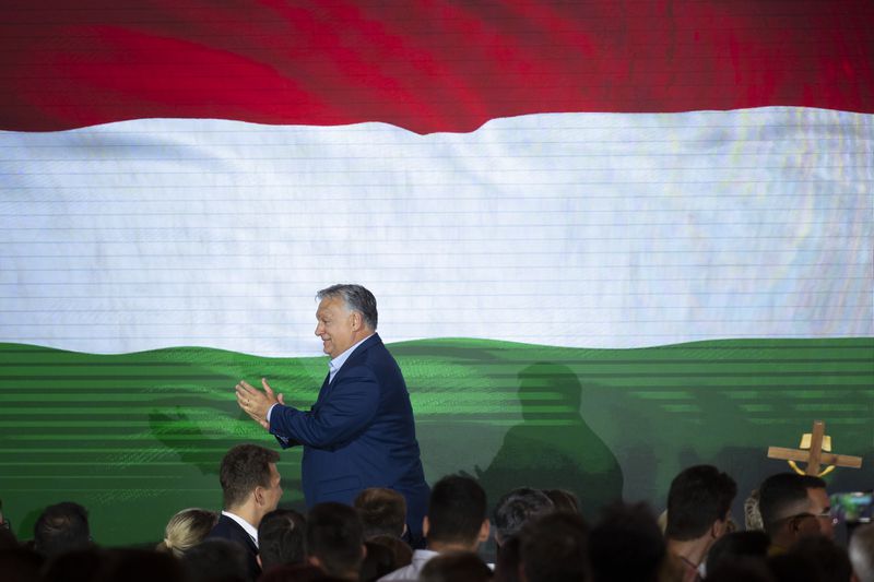 Hungarian Prime Minister Viktor Orban claps after addressing the media after receiving the results of the European Parliamentary elections in Budapest, Hungary, Monday, June 10, 2024. (AP Photo/Denes Erdos)