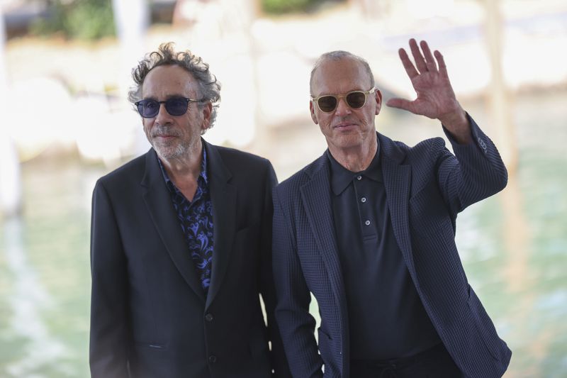 Director Tim Burton, left, and Michael Keaton pose for photographers upon arrival for the press conference of the film 'Beetlejuice Beetlejuice' during the 81st edition of the Venice Film Festival in Venice, Italy, on Wednesday, Aug. 28, 2024. (Photo by Vianney Le Caer/Invision/AP)