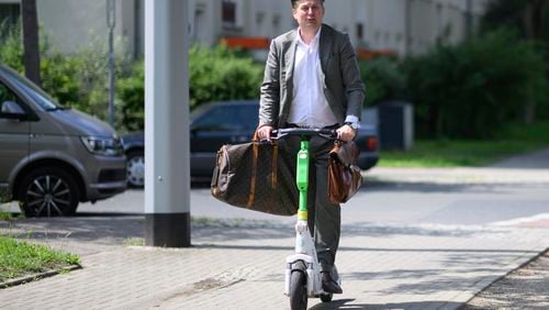 Far-right Alternative for Germany (AfD) top candidate for the European Parliament elections Maximilian Krah leaves a polling station on an e-scooter after casting his vote in the European and local elections in Dresden, Germany, Sunday, June 9, 2024. (Robert Michael/dpa via AP)