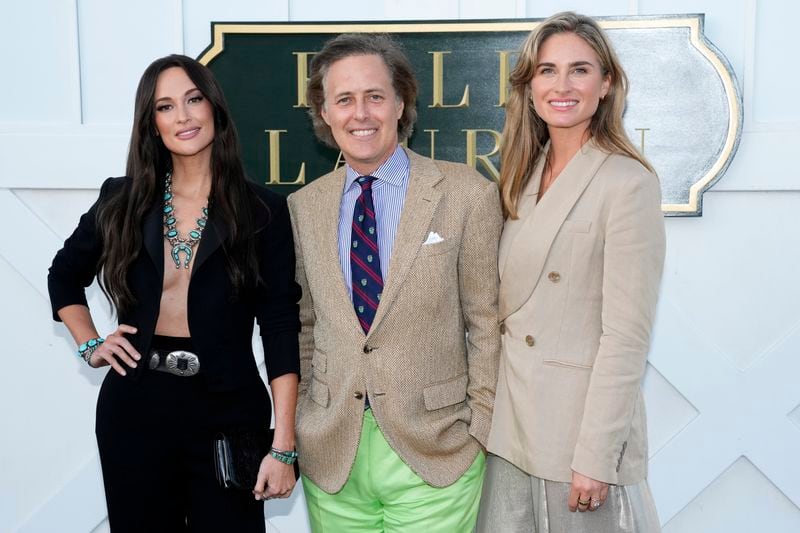 Kacey Musgraves, from left, David Lauren and Lauren Bush Lauren attend the Ralph Lauren Spring/Summer 2025 fashion show as part of New York Fashion Week on Thursday, Sept. 5, 2024, at Khalily Stables in Bridgehampton, N.Y. (Photo by Charles Sykes/Invision/AP)