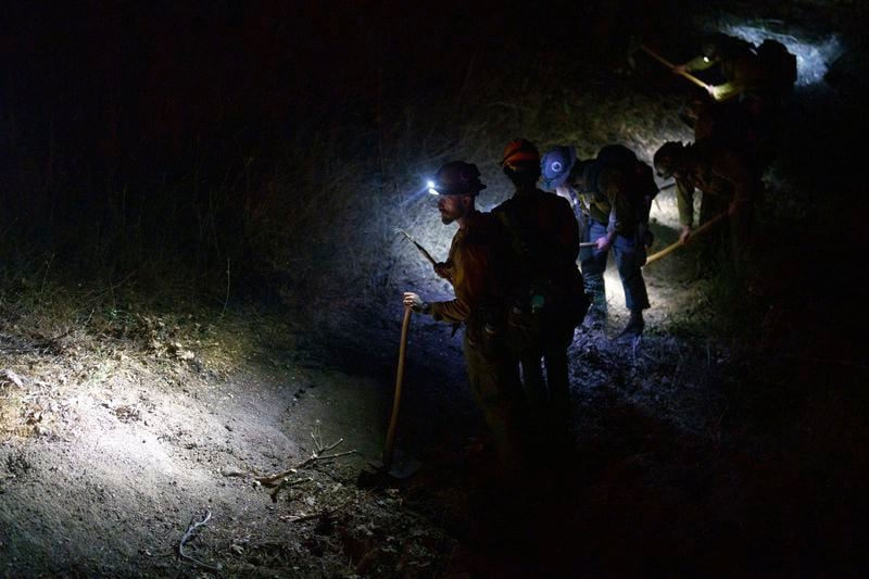 Firefighting hand crews cut lines against the advancing Line Fire in Running Springs, Calif., Monday, Sept. 9, 2024. (AP Photo/Eric Thayer)