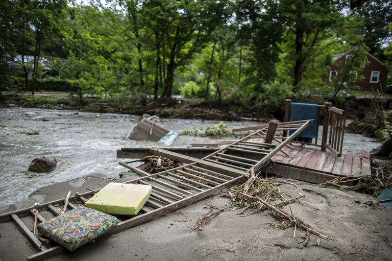 Debris are seen after a flash flood has hit the Plainfield of Vermont last night, destroying two bridges and plenty of private houses, Thursday, July 11, 2024. (AP Photo/Dmitry Belyakov)