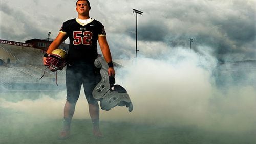 072114 HOSCHTON: Offensive lineman Kaleb Kim poses for a portrait on the football field at Mill Creek High School on Monday, July 21, 2014, in Bogart. CURTIS COMPTON / CCOMPTON@AJC.COM Mill Creek offensive lineman Kaleb Kim