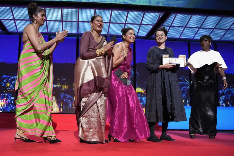 Kani Kusruti, from left, Chhaya Kadam, Divya Prabha and director Payal Kapadia accept the grand prize award for 'All We Imagine as Light,' alongside Viola Davis, far right, during the awards ceremony of the 77th international film festival, Cannes, southern France, Saturday, May 25, 2024 (Photo by Andreea Alexandru/Invision/AP)