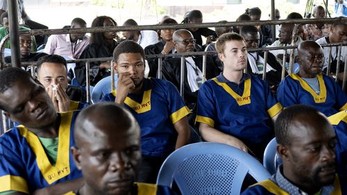 FILE - Back row from left, Benjamin Reuben Zalman-Polun, Marcel Malanga and Tyler Thompson, all American citizens, attend a court verdict in Congo, Kinshasa, Friday, Sept. 13, 2024, on charges of taking part in a coup attempt in May 2024. (AP Photo/Samy Ntumba Shambuyi, File)