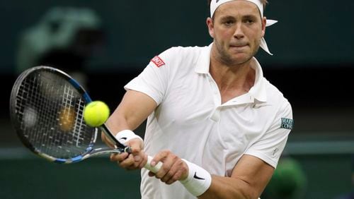 FILE - Marcus Willis of Britain returns to Roger Federer of Switzerland during their men's singles match on day three of the Wimbledon Tennis Championships in London, Wednesday, June 29, 2016. Willis, the Everyman's everyman who faced Roger Federer at Centre Court while ranked 772nd in 2016, was back at Wimbledon on Thursday, July 4, 2024, competing in men's doubles and hoping he might get to have a bit of a reunion with the now-retired eight-time champion at the All England Club.(AP Photo/Tim Ireland, File)