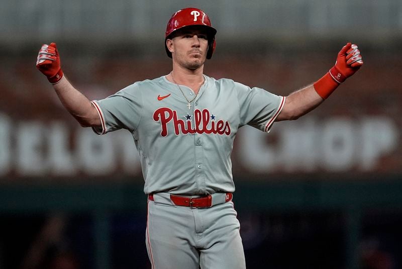 Philadelphia Phillies catcher J.T. Realmuto (10) celebrates hitting an RBI-double in the seventh inning of a baseball game against the Atlanta Braves, Thursday, Aug. 22, 2024, in Atlanta. (AP Photo/Mike Stewart)