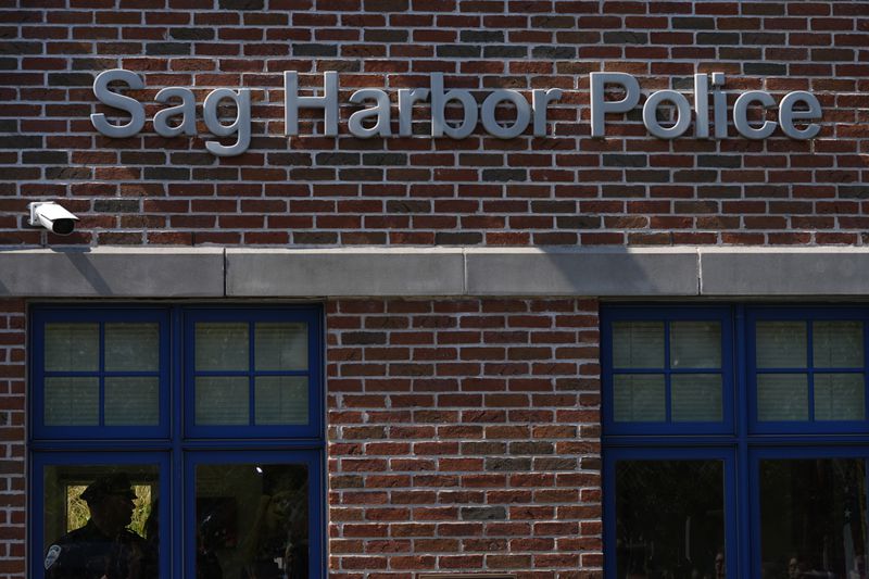 A police officer stands inside the Sag Harbor Police station during Justin Timberlake's hearing, Friday, Sept. 13, 2024, in Sag Harbor, N.Y. (AP Photo/Pamela Smith)