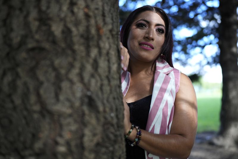 Julieth Luna Garcia, a transgender woman from El Salvador, poses for photos at Horner Park in Chicago, Monday, Sept. 30, 2024. (AP Photo/Nam Y. Huh)