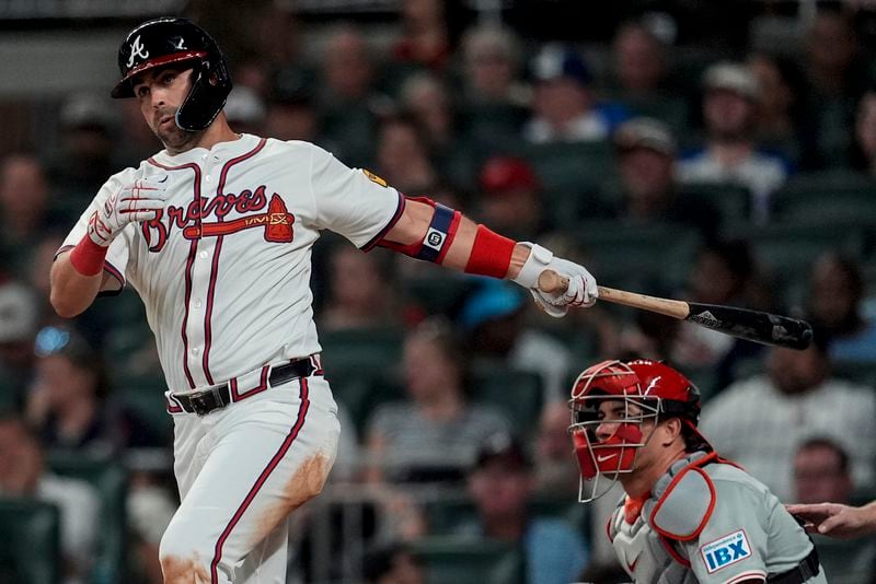 Atlanta Braves outfielder Whit Merrifield (15) hits a double against the Philadelphia Phillies during the fifth inning of a baseball game, Tuesday, Aug. 20, 2024, in Atlanta. (AP Photo/Mike Stewart)