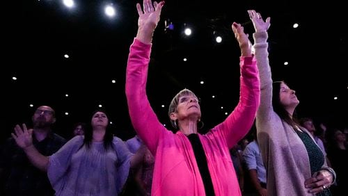 A member prays during a Sunday service at Bethlehem Church, Sunday, Sept. 8, 2024, in Bethlehem, Ga. Colt Gray, 14, has been charged with murder over the killing of two students and two teachers at Apalachee High School in Barrow County, outside Atlanta, on Wednesday. (AP Photo/Mike Stewart)