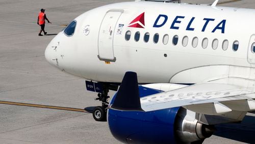 FILE - A Delta Air Lines jet leaves the gate, Friday, July 19, 2024, at Logan International Airport in Boston. Some airline issues are continuing on Monday after a faulty software update caused technological havoc worldwide and resulted in several carriers grounding flights, but the number of flights impacted is declining. (AP Photo/Michael Dwyer, File)