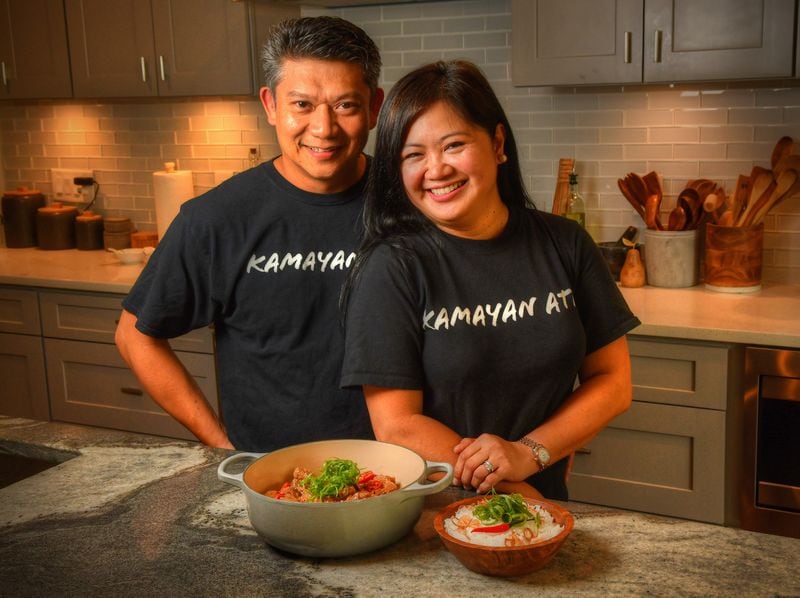 Carlo Gan (left) and Amor Mia Oriño, who have the Filipino pop-up and catering business Kamayan ATL, are shown in their Decatur home with the dish sinilihan, which is more widely known as Bicol Express. It's pork stew in coconut milk with chiles. Styling by Amor Mia Oriño and Carlo Gan / Chris Hunt for The Atlanta Journal-Constitution