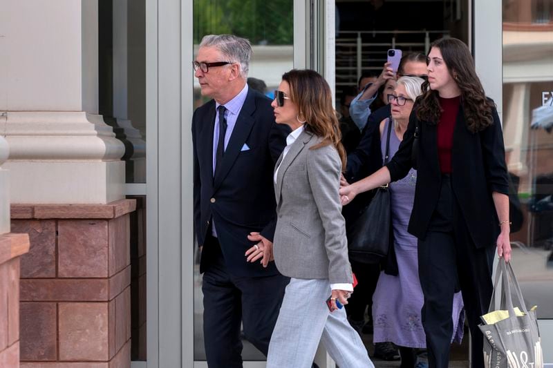 Actor Alec Baldwin, left, and his wife Hilaria leave court the judge threw out his involuntary manslaughter case for the 2021 fatal shooting of cinematographer Halyna Hutchins during filming of the Western movie "Rust," Friday, July 12, 2024, in Santa Fe, N.M. (Eddie Moore/The Albuquerque Journal via AP)